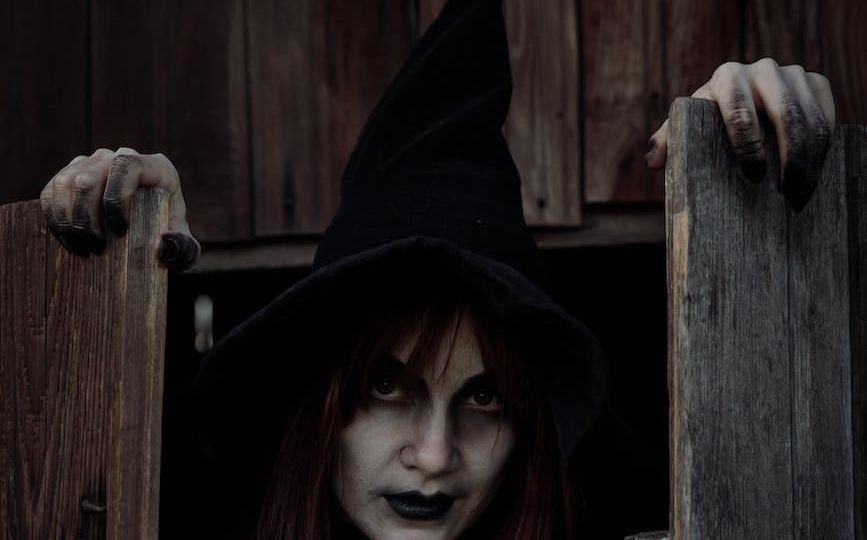 witch holding wooden doors